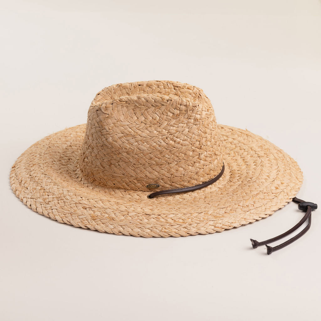 Natural colored straw hat with a wide brim and brown loose drawstrings on a light beige background