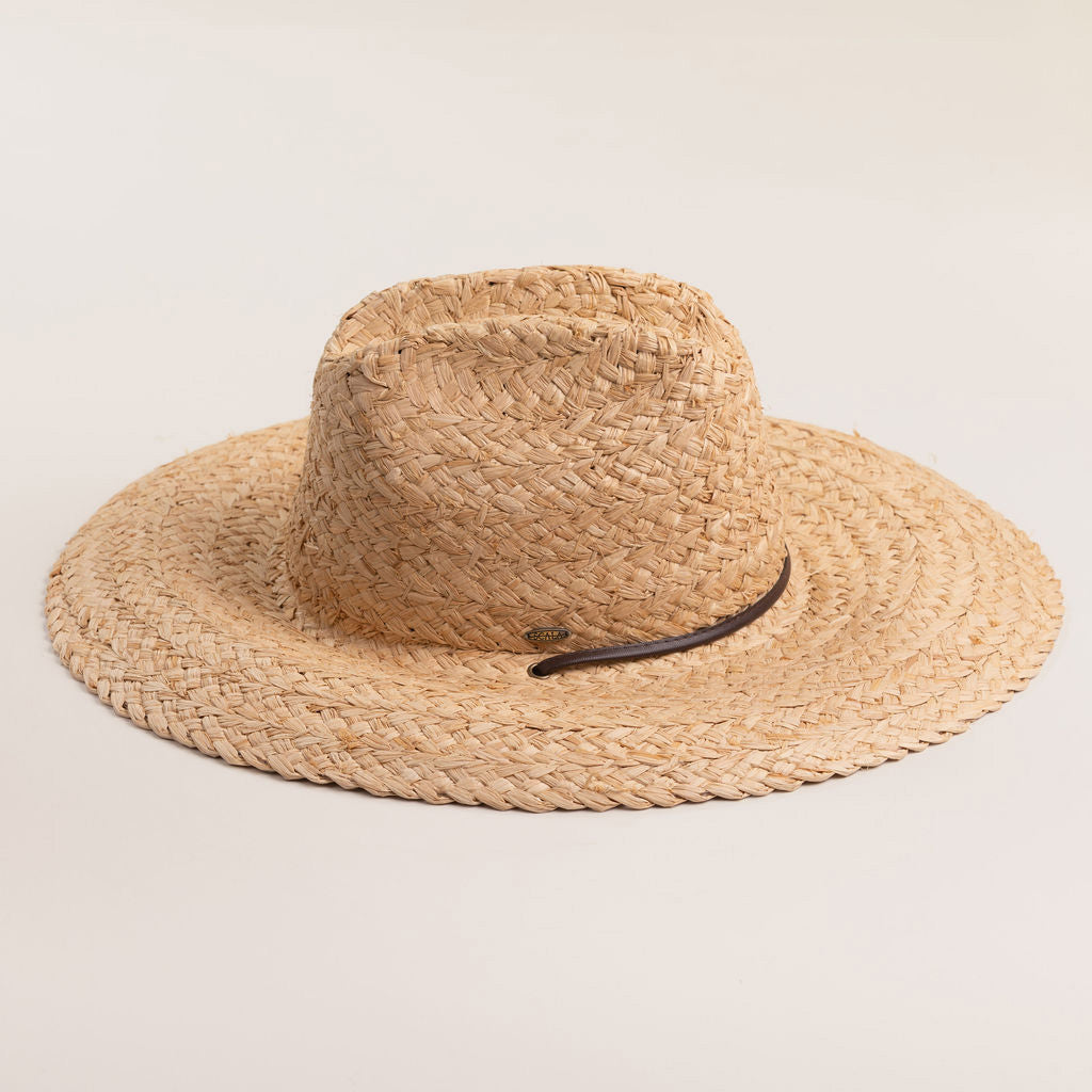 Natural colored straw hat with a wide brim on a light beige background