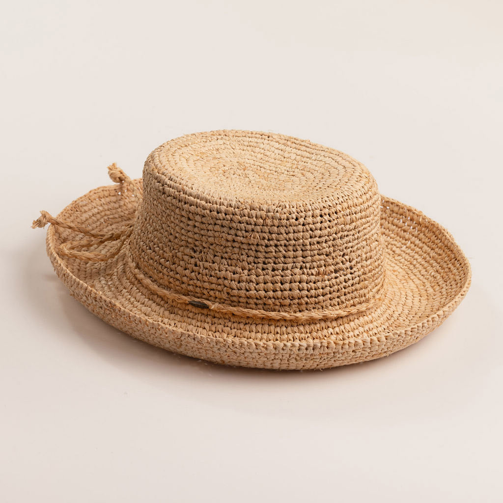 Natural colored straw hat on a light beige background
