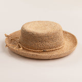 Natural colored straw hat on a light beige background