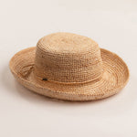 Natural colored straw hat on a light beige background