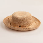 Natural colored straw hat on a light beige background