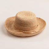 Natural colored straw hat on a light beige background