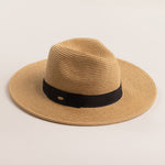 Toast colored straw hat with a black band on a light beige background