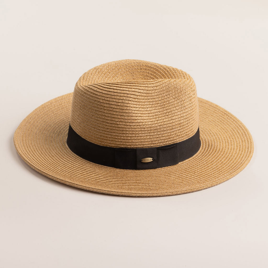 Toast colored straw hat with a black band on a light beige background