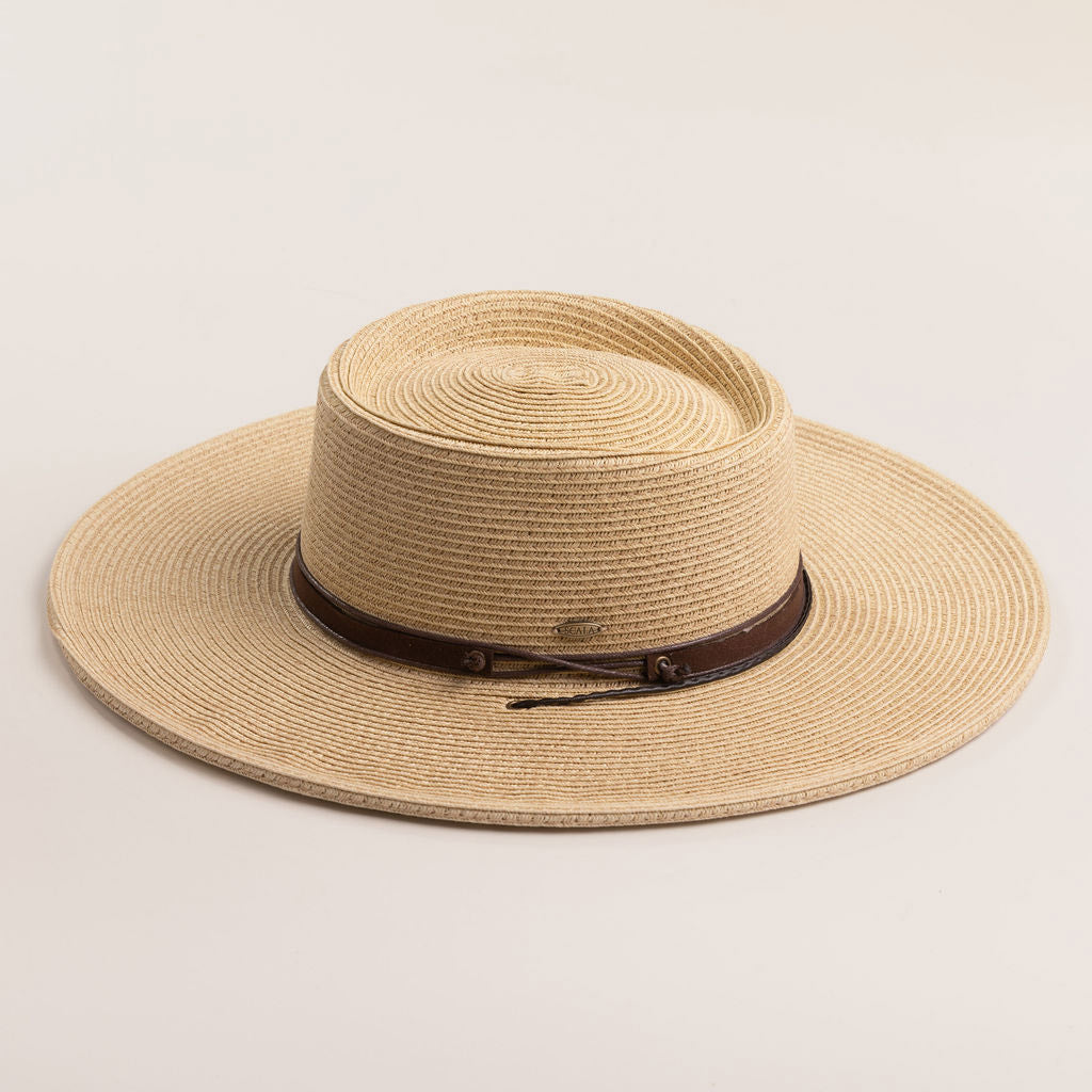 Natural colored straw hat with a brown band on a light beige background