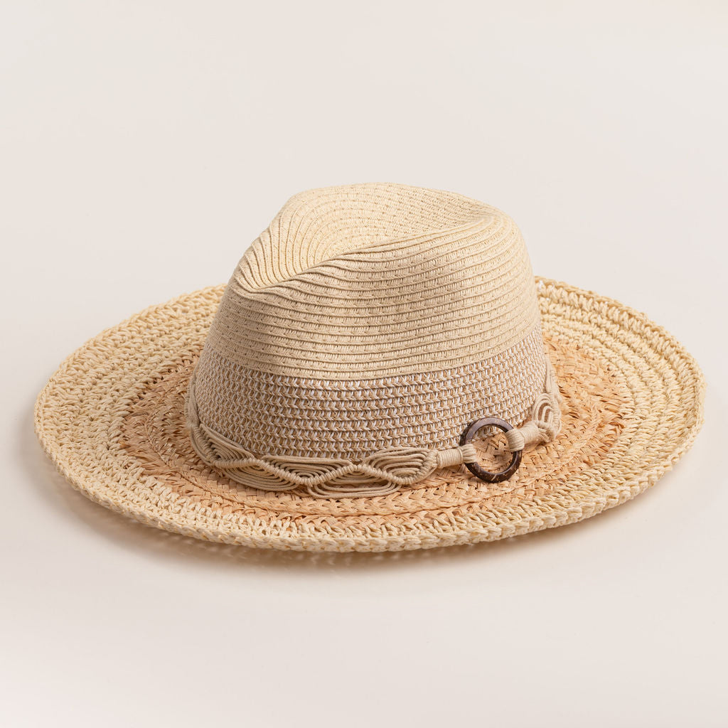 Two-toned straw hat with a natural colored brim and white top on a light beige background