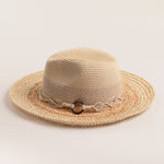 Two-toned straw hat with a natural colored brim and white top on a light beige background