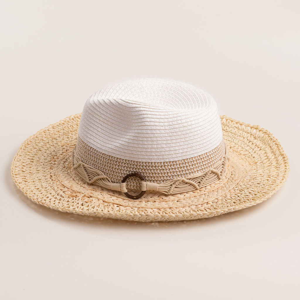 Two-toned straw hat with a beige brim and white top on a light beige background