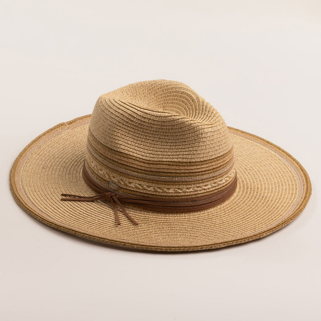 Natural colored straw hat in shades of brown with a wide brim on a light beige background