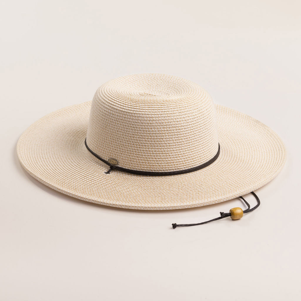 Ivory colored straw hat with a black band on a light beige background