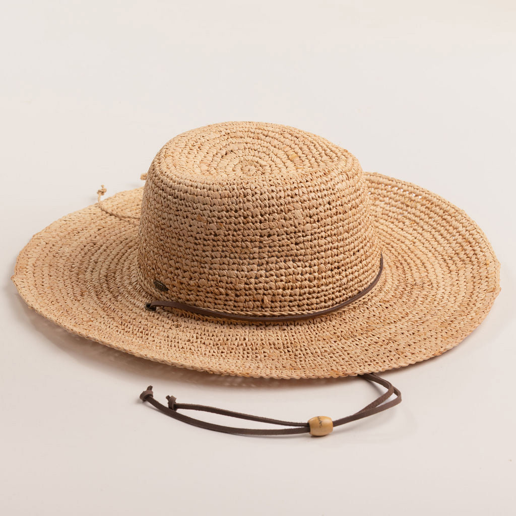 Natural colored straw hat on a light beige background