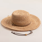 Natural colored straw hat on a light beige background