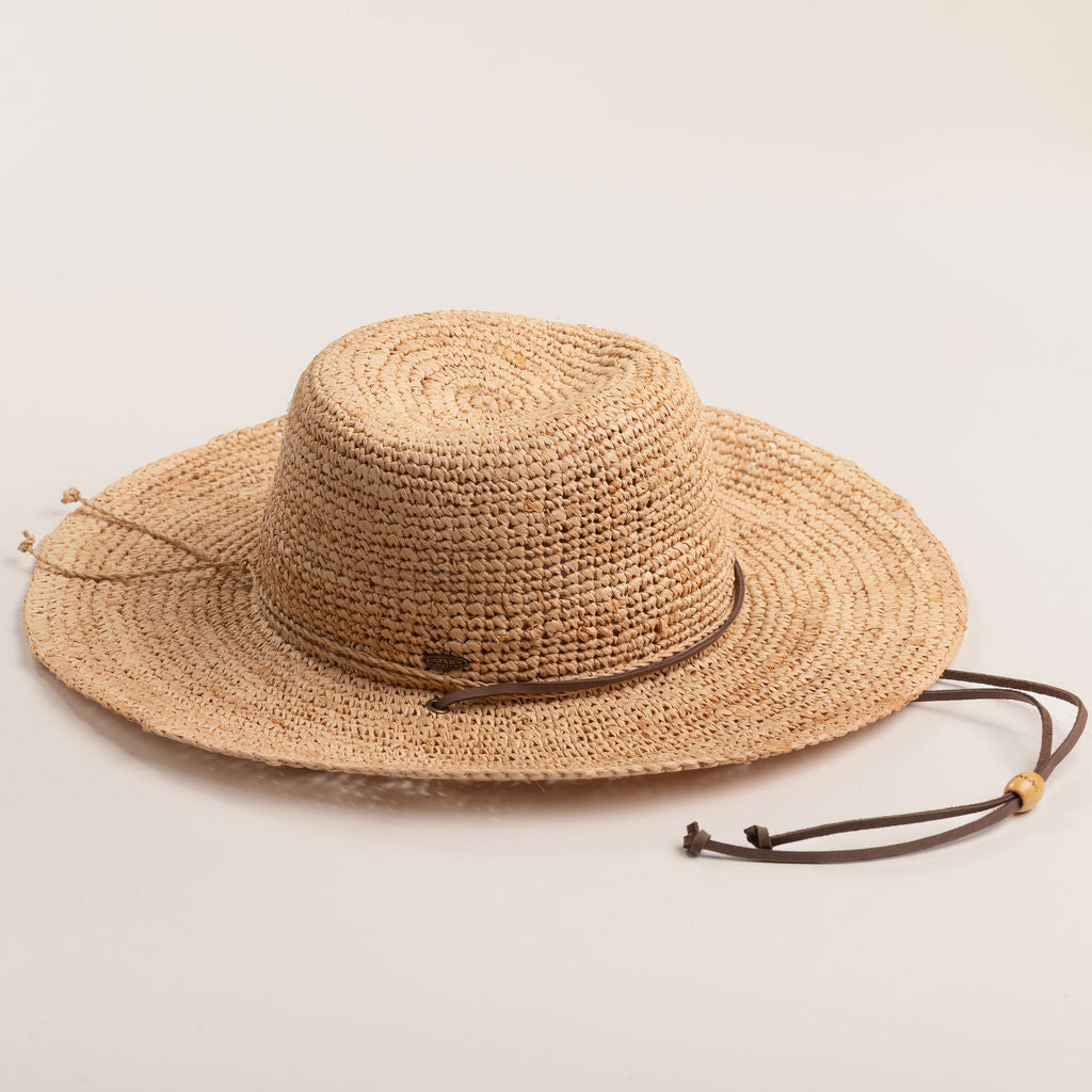 Natural colored straw hat on a light beige background