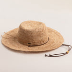Natural colored straw hat on a light beige background