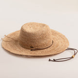 Natural colored straw hat on a light beige background