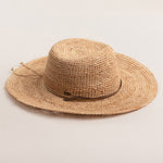 Natural colored straw hat on a light beige background