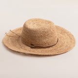 Natural colored straw hat on a light beige background