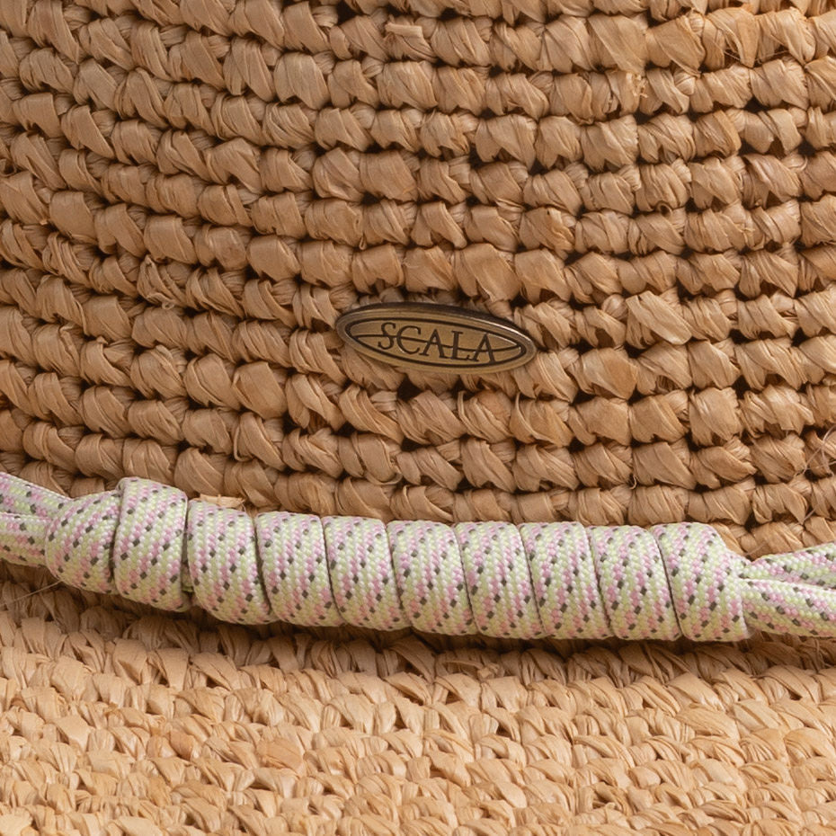 Close-up of a natural colored hat with a Scala logo pin and decorative rope-like band in dotted green, pink, gray, and white colors