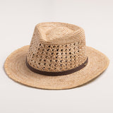 Natural colored straw hat with a brown band on a light gray background