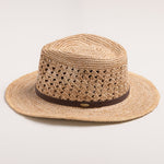 Natural colored straw hat with a brown band on a light gray background
