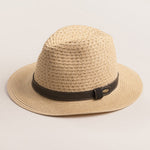 Natural colored straw hat with a brown band on a light beieg background