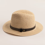 Natural colored straw hat with a brown band on a light beieg background