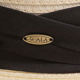 Close-up of an ivory colored hat with a thick black band and Scala logo pin on top of it