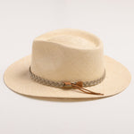 Natural colored straw hat with sandy colored braided band and brown small ribbon on a light gray background