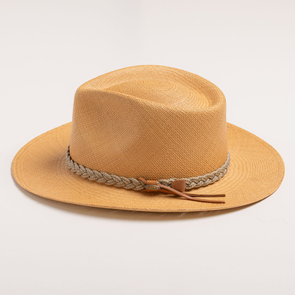 Putty colored straw hat with sandy colored braided band and brown small ribbon on a light gray background