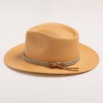 Putty colored straw hat with sandy colored braided band and brown small ribbon on a light gray background