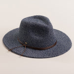 Denim colored straw hat with a brown band on a light beige background