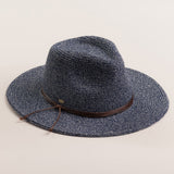 Denim colored straw hat with a brown band on a light beige background