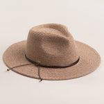Taupe colored straw hat with a brown band on a light beige background