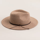 Taupe colored straw hat with a brown band on a light beige background