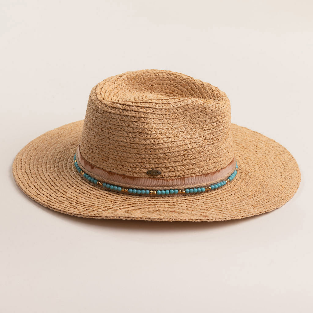 Natural colored straw hat with a decorative band on a light beige background