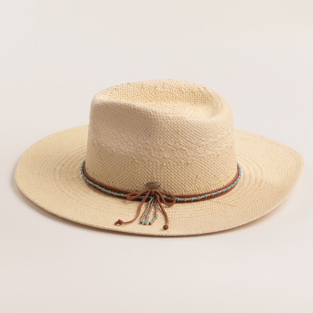 Natural colored straw hat with decorative band on a light beige background